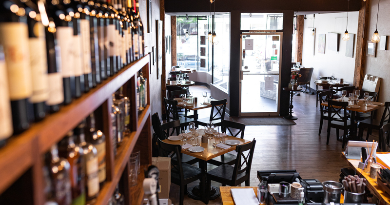 Interior, tables with tableware and wine shelves