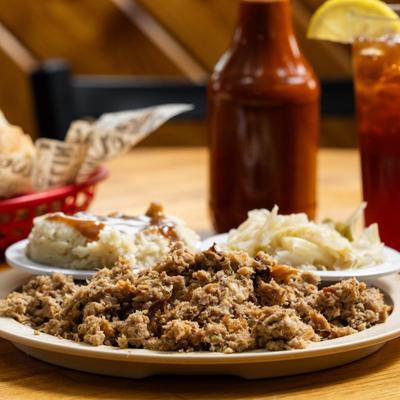 Pulled pork plate with mashed potatoes with gravy and coleslaw.