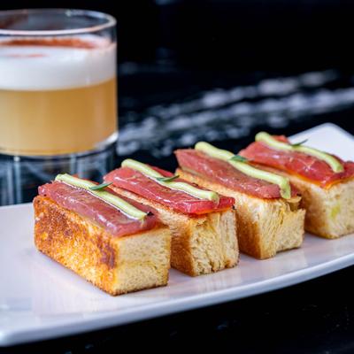 Tuna slices on brioche bread, with confit peppers, and avocado.