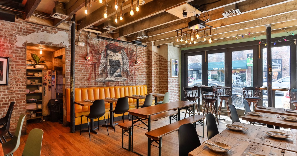 Cozy café with brick walls, yellow booth seating