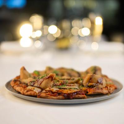 Chat Samosa Naan Pizza served on the table.