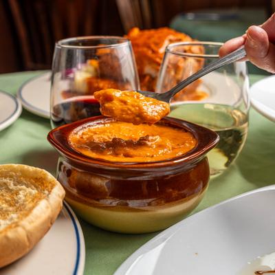 North Fork Chowder soup, person holding a spoon and getting some of it.
