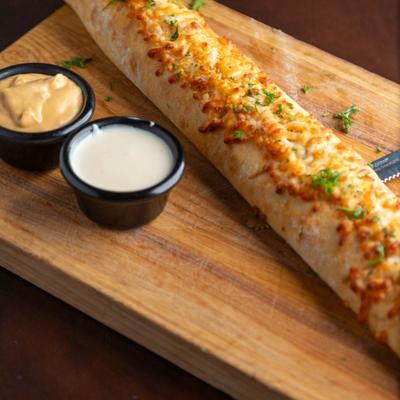 French bread stuffed with mozzarella and Italian herb butter, served with dipping sauces.