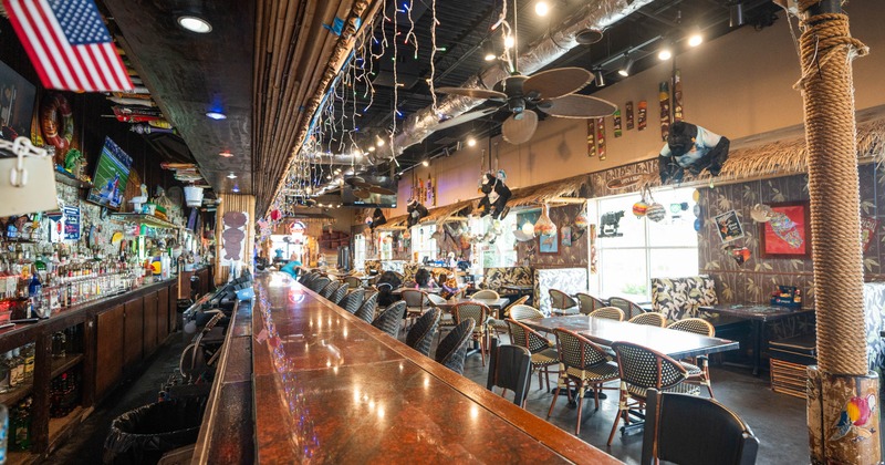 Interior, bar area on the left, tables and chairs on the right