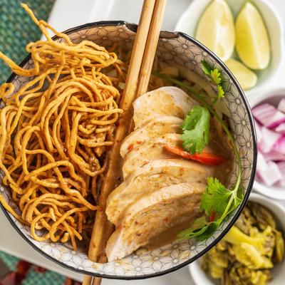 Thai Curry Noodle Soup with condiments.