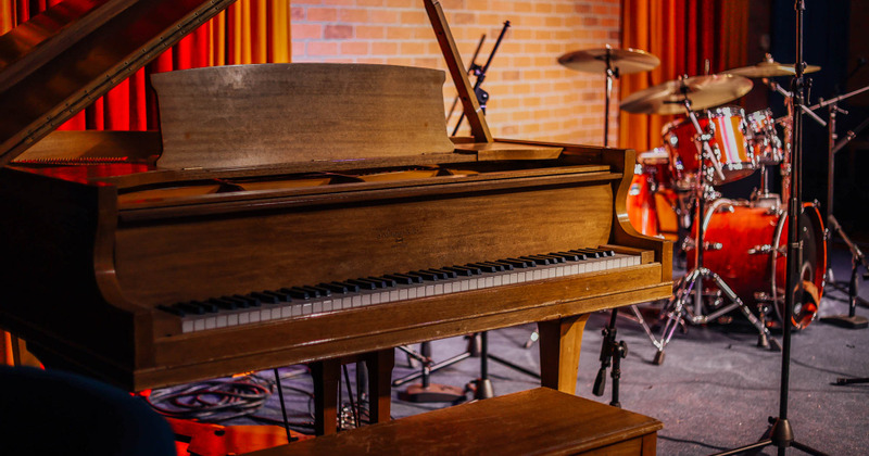 Stage detail, a piano and drums