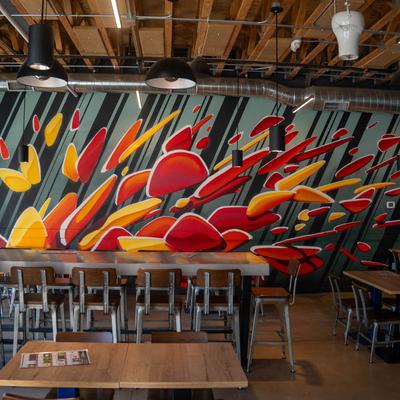 Seating area, colorful wall mural.