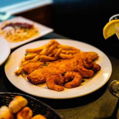 Fried walleye and fried shrimp served with fries.
