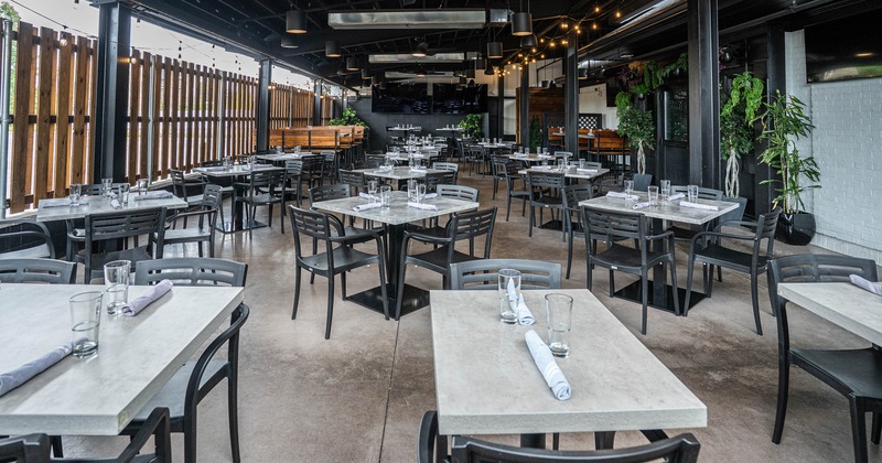 Covered patio dining area with set tables