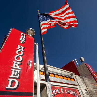 Hook and Ladder Pizza Co food truck with an American flag and Get Hooked slogan.