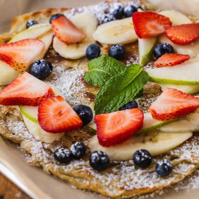 Roti flatbread, topped with fresh fruits and coconut ice cream.