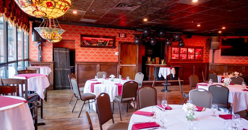 Governor's hall space with round tables set up for dining