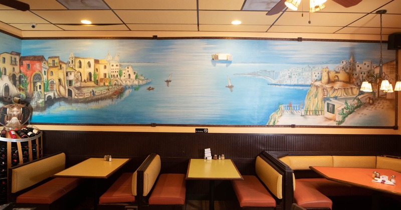 Interior, low back booth seating, wall mural painting of a bay