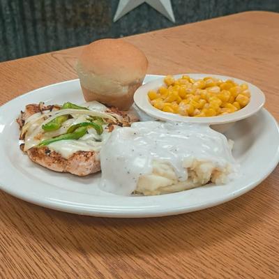 A steak with mashed potatoes and corn.