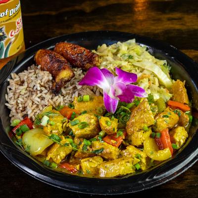 Vegetarian Tofu Curry served with rice, peas, and cabbage.