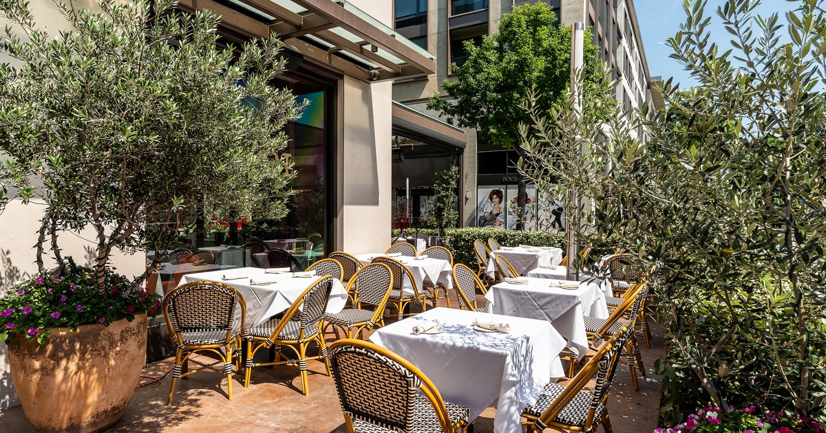 Cozy outdoor dining area with tables ready for guests