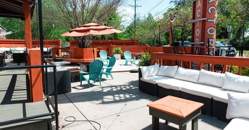 Exterior seating area with chairs, coffee tables, garden sofas and parasols