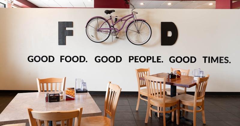 Dining tables and a wall mounted bicycle