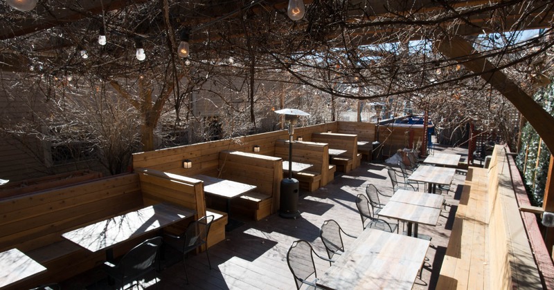 Exterior, partially covered seating area, outdoor heater, multiple light bulbs on the ceiling