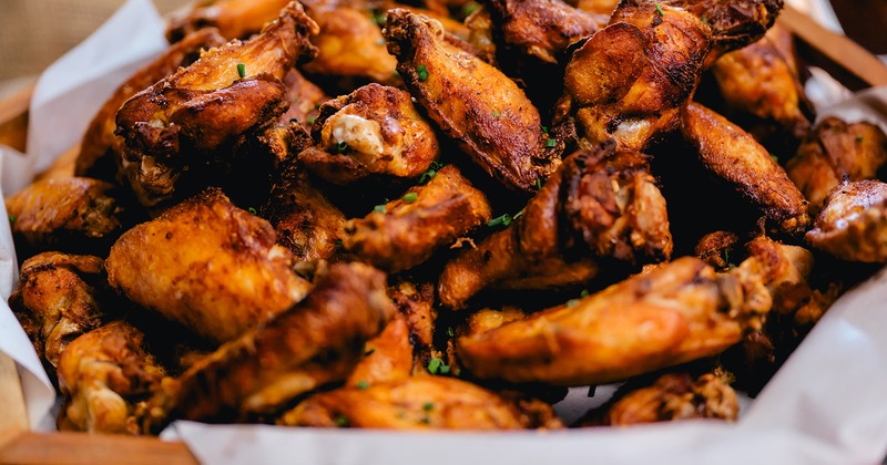 Chicken wings tossed in a dry spice rub, garnished with chives