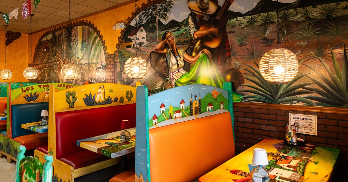 Lively and cozy Mexican-style interior dining area with colorful dining booths along the wall
