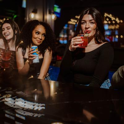 Girls drinking at the bar.