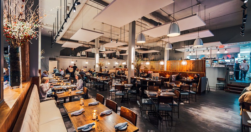 Interior space, dining area, guests chatting and enjoying their food and drinks