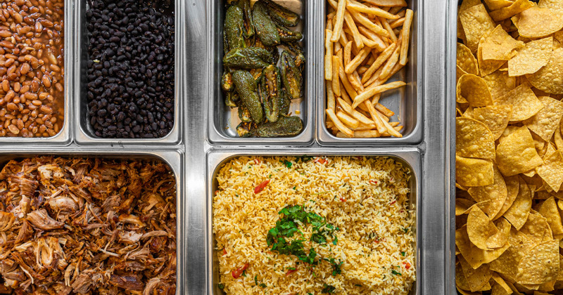 Top view of a salad bar with different condiments and side dishes