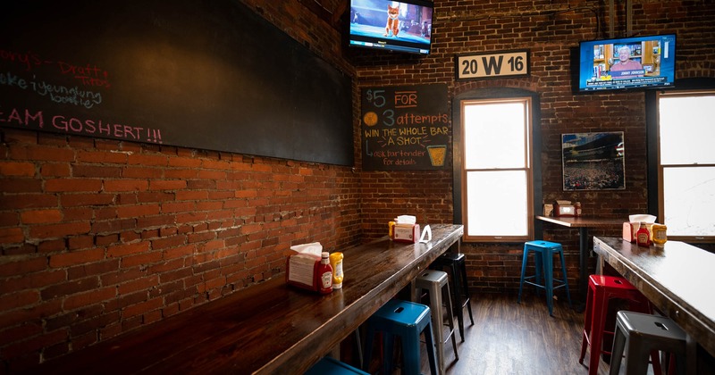 Inside, a long table with chairs, and a TV on the wall