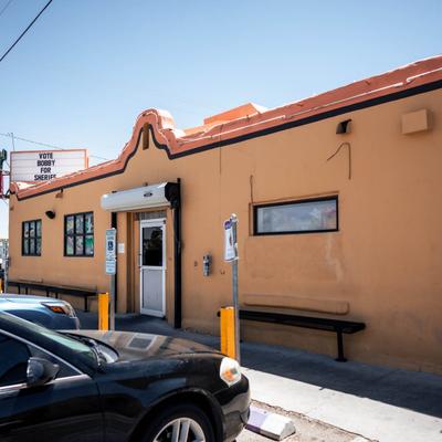 Exterior with signage, parked cars.