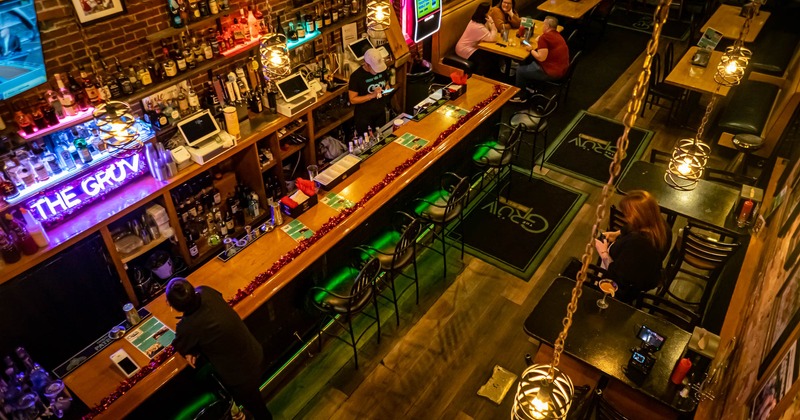 Interior, overhead view, tables, chairs and bar stools, bar on the left