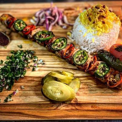 Veggie kabob served with rice and pickled vegetables.