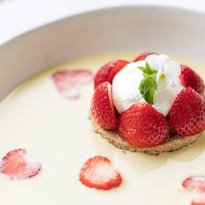 Strawberry dessert with whipped cream served in a creamy sauce.