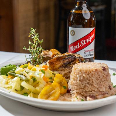 Jerk chicken with veggies and rice.