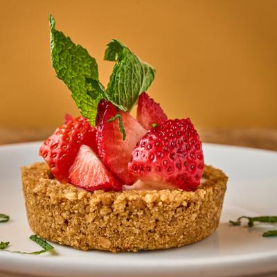 Tart topped with strawberries and mint.