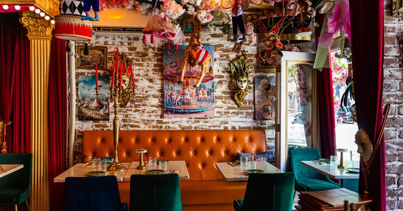 Interior, large leather bench and marble tables, decor on the walls