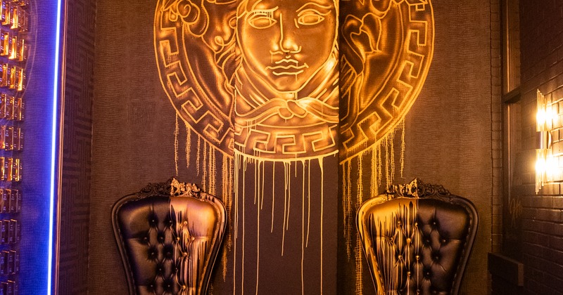 Interior, 2 royal armchairs, decorated wall behind