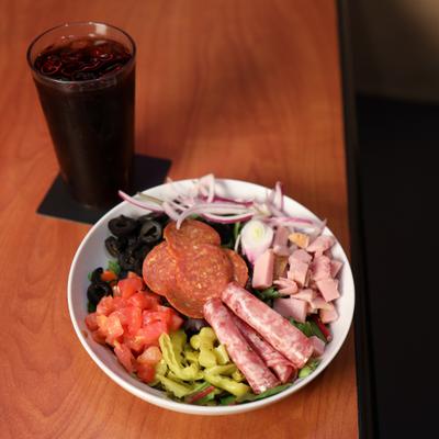 Antipasto salad and a cocktail drink.