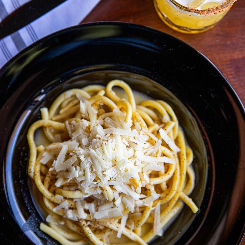 Bucatini Cacio E Pepe & Black Truffle on Pecorino Cheese Wheel (V) photo