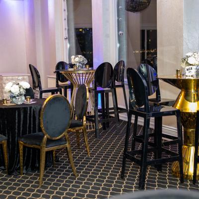 Black and gold high tables and high stools.