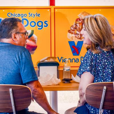 Two people sitting at a table in a fast-food restaurant.
