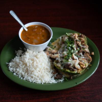 Plato Verde with chicken and beef fajita, grilled avocado, rice and charro beans.