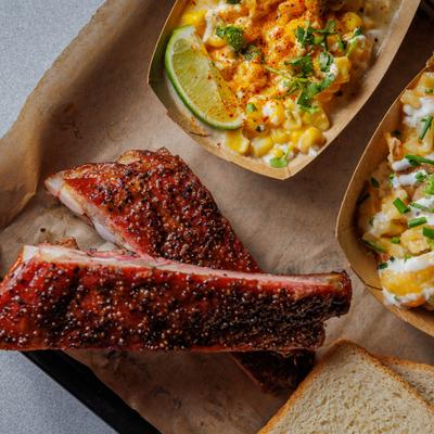 One meat platter, ribs with side dishes.