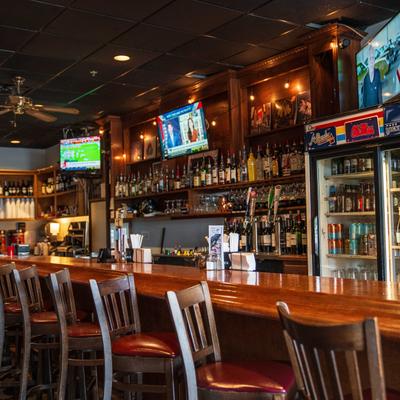Interior, bar, bar stools, drink rack behind bar.