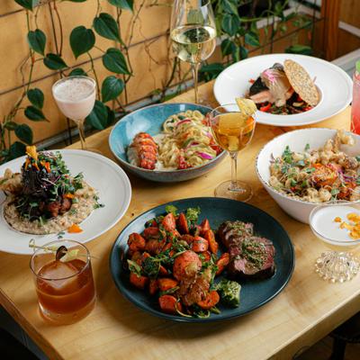 Assorted dishes and drinks on a table, angle top view