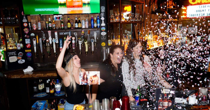 People having fun behind the bar