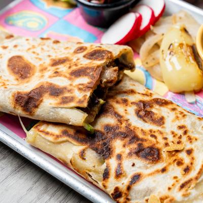 Toasted quesadilla slices on tray.