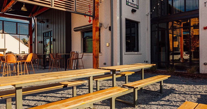 Exterior seating area, wooden tables and wooden benches