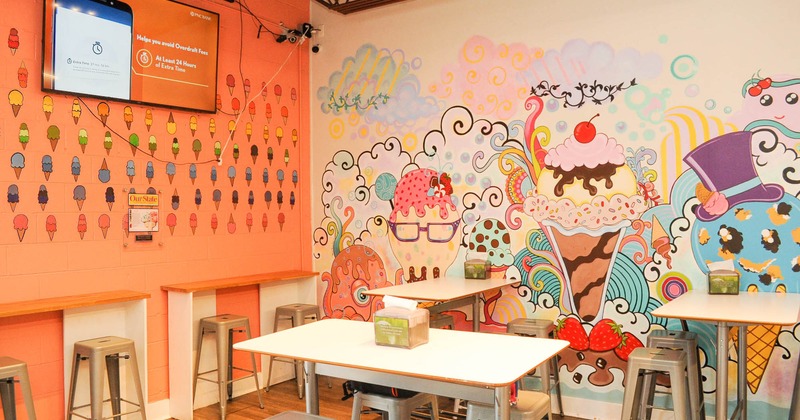 Interior, tables and seating in a corner with mural art on the walls