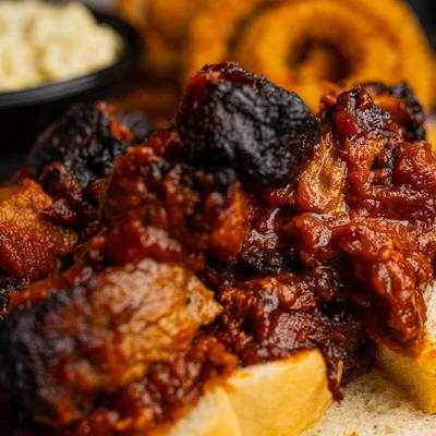 Close up of burnt ends with sides.